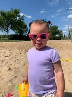 toddler in pink sunglasses