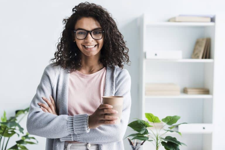 women holding cup with eyeglasses