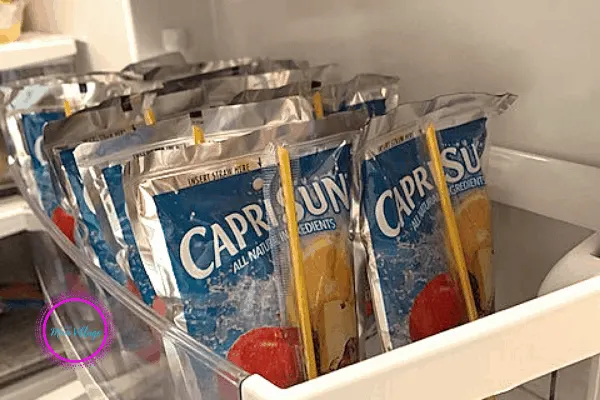 organizing kids drinks on fridge shelf