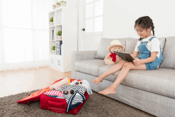 Little girl sitting on couch do homework