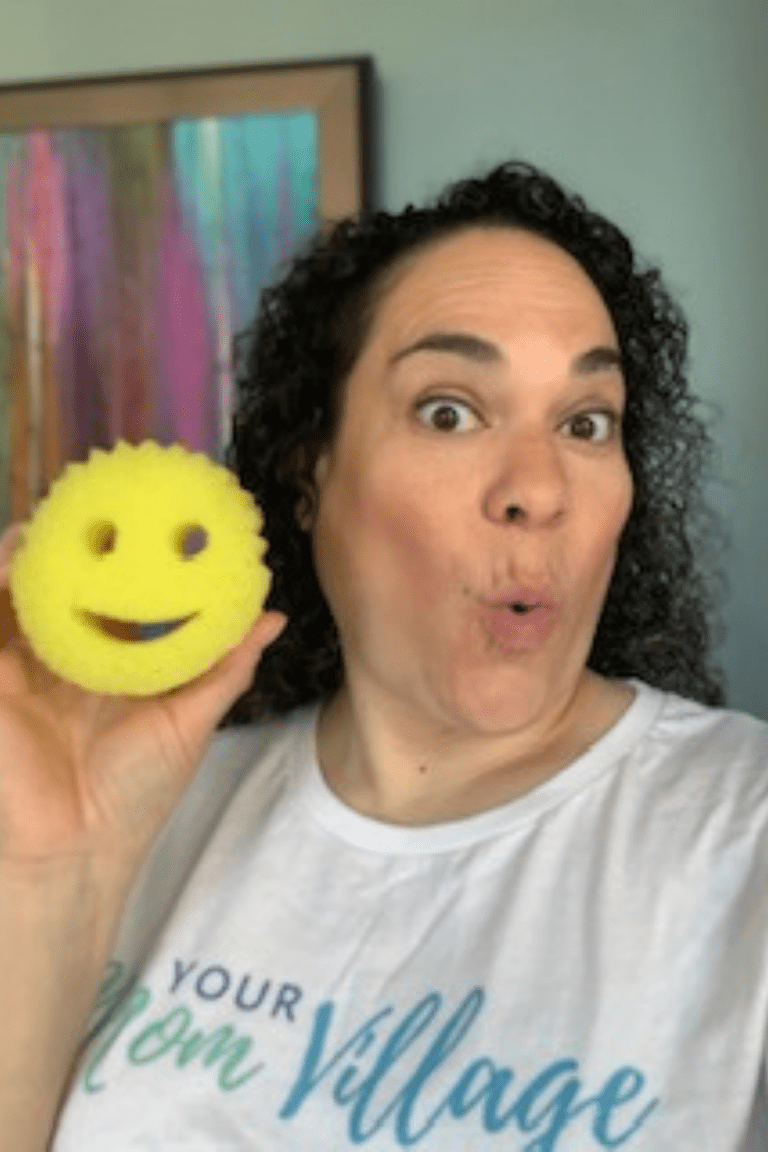woman holding a scrub daddy sponge