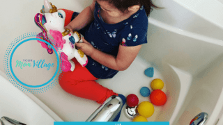 Toddler playing with toys in bath tub