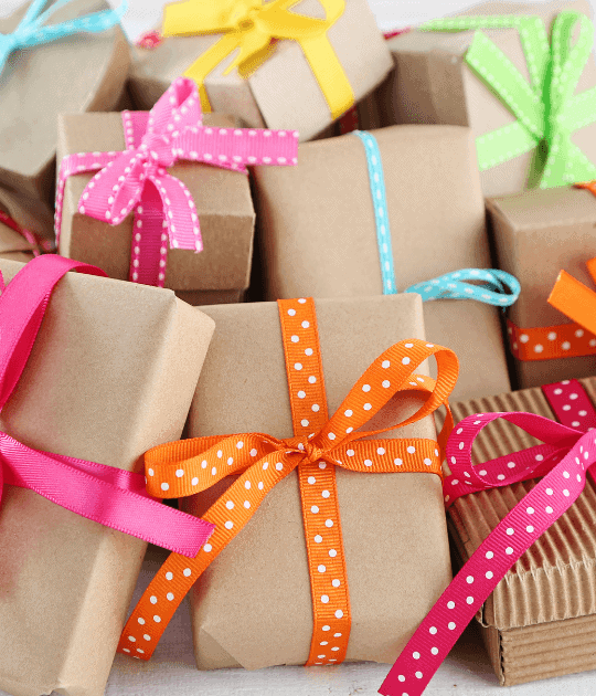 Gifts wrapped in brown paper and colored bows