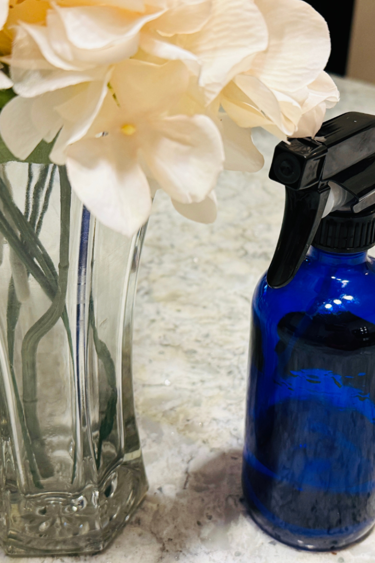 Cleaning spray bottle by flower vase