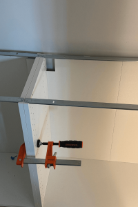 White base cabinets getting installed into a pantry