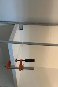 White base cabinets getting installed into a pantry