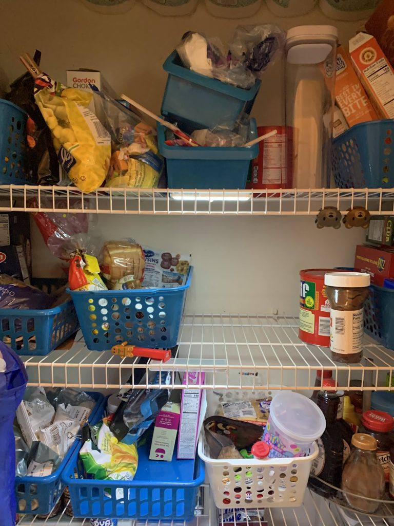 Messy pantry with food on wire shelfs