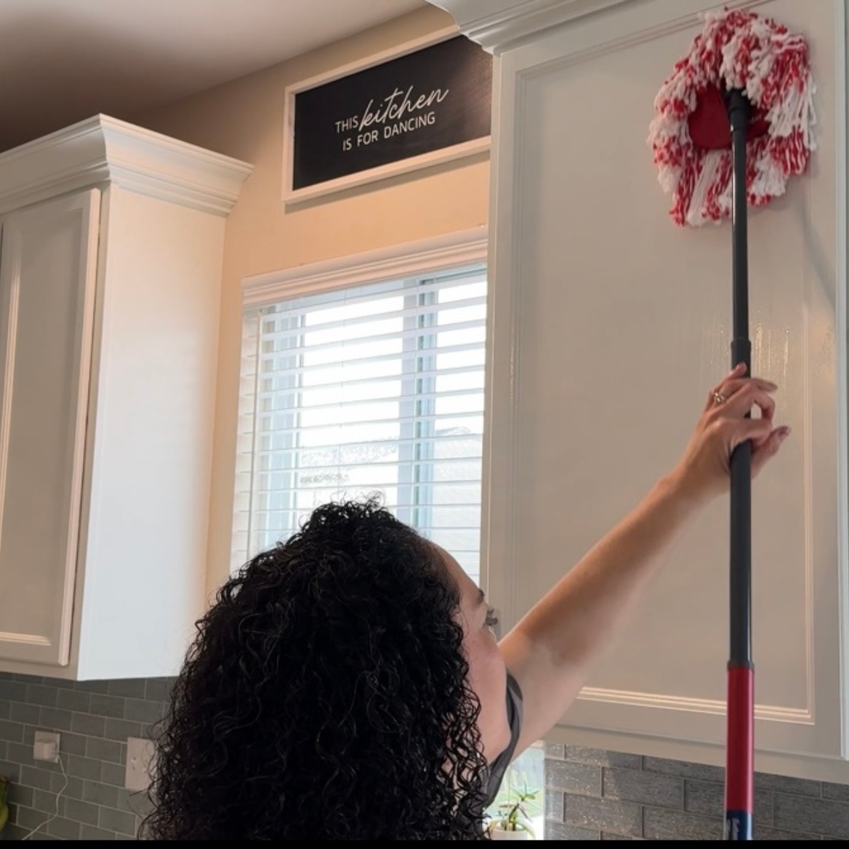 Women cleaning kitchen cabinets