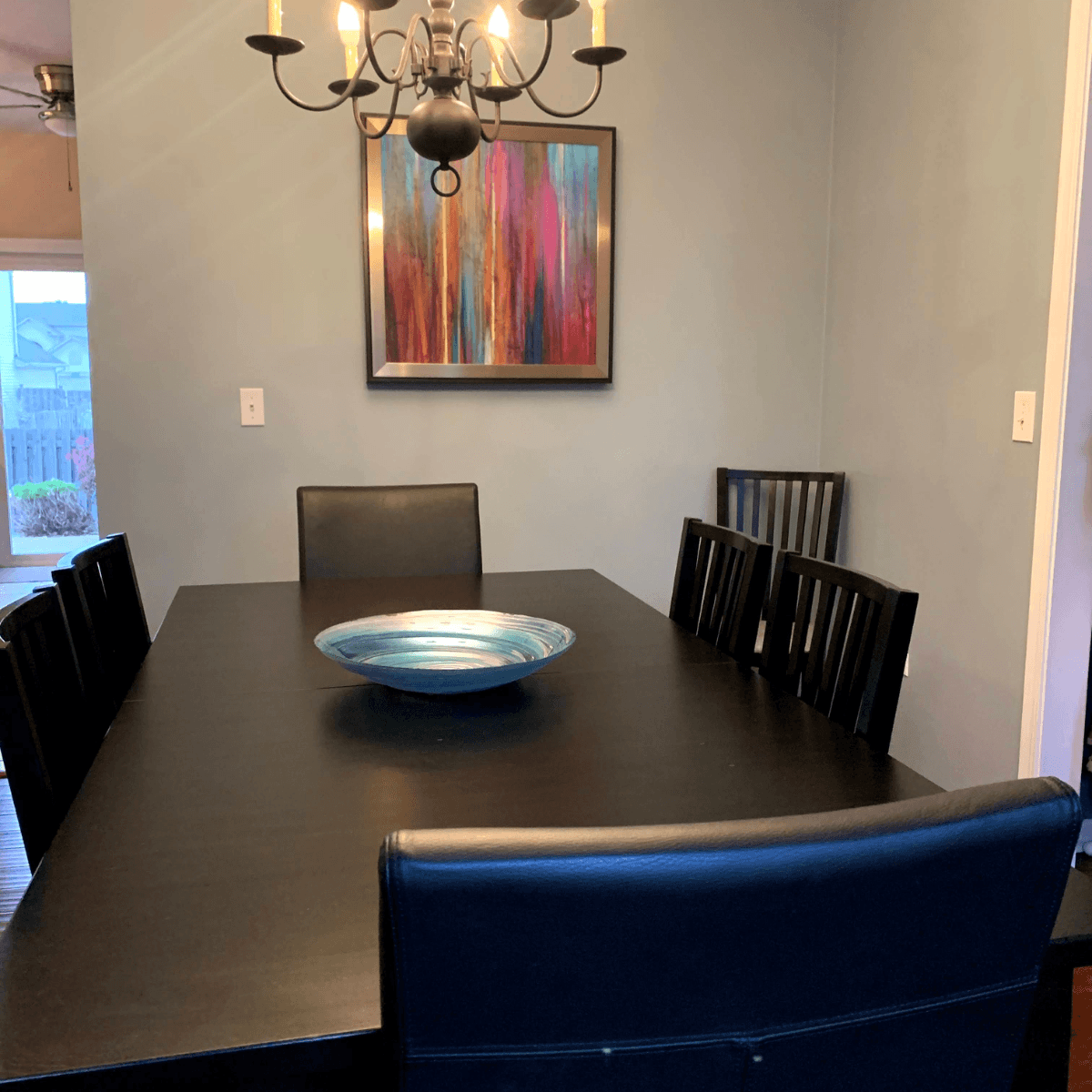 Cleaning dinning room with black table and chairs
